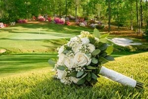 A brides lovely bouquet laying on the green of one of the many beautiful holes on the dancing rabbit Azalea's golf course